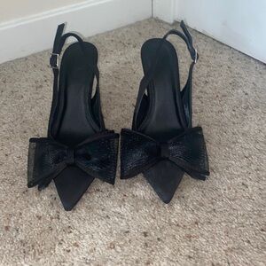 Black strappy heels with bow